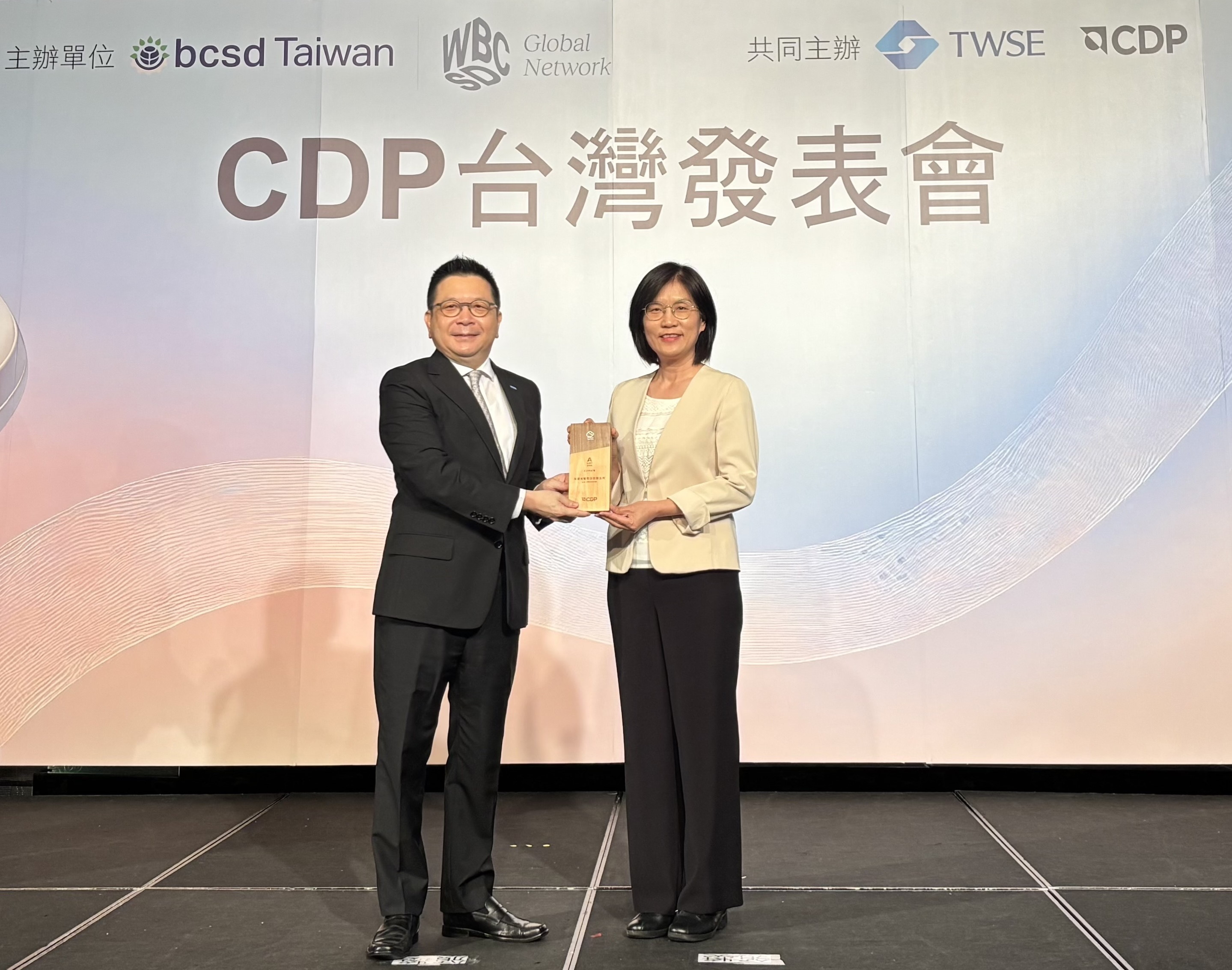 友達永續成果再獲國際評比肯定，獲頒CDP氣候與水資源雙項領導力評級。今由臺灣證券交易所董事長林修銘（左）頒獎，友達光電永續長古秀華（右）代表受獎